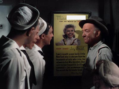 Jules Munshin, Frank Sinatra and Gene Kelly in On The Town looking at a poster of Vera-Ellen