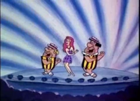 Fred and Barney dancing with Ann-Margrock, Ann-Margret in The Flintstones "Ann-Margrock Presents"