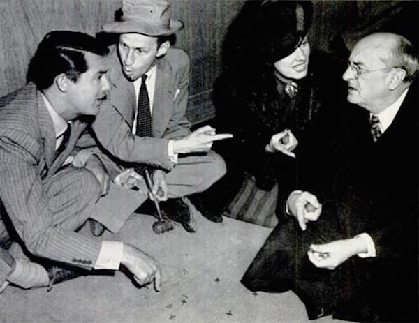 Director Garson Kanin, Cary Grant, Irene Dunne and Granville Bates in a game of jacks in between takes of My Favorite Wife, 1940 600px