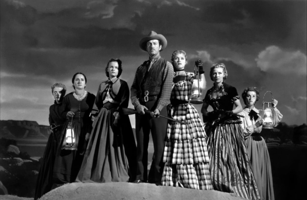 Julie Bishop, Denise Darcel, Beverly Dennis, Robert Taylor, Hope Emerson, Marilyn Erskine, and Lenore Lonergan in Westward the Women (1951)